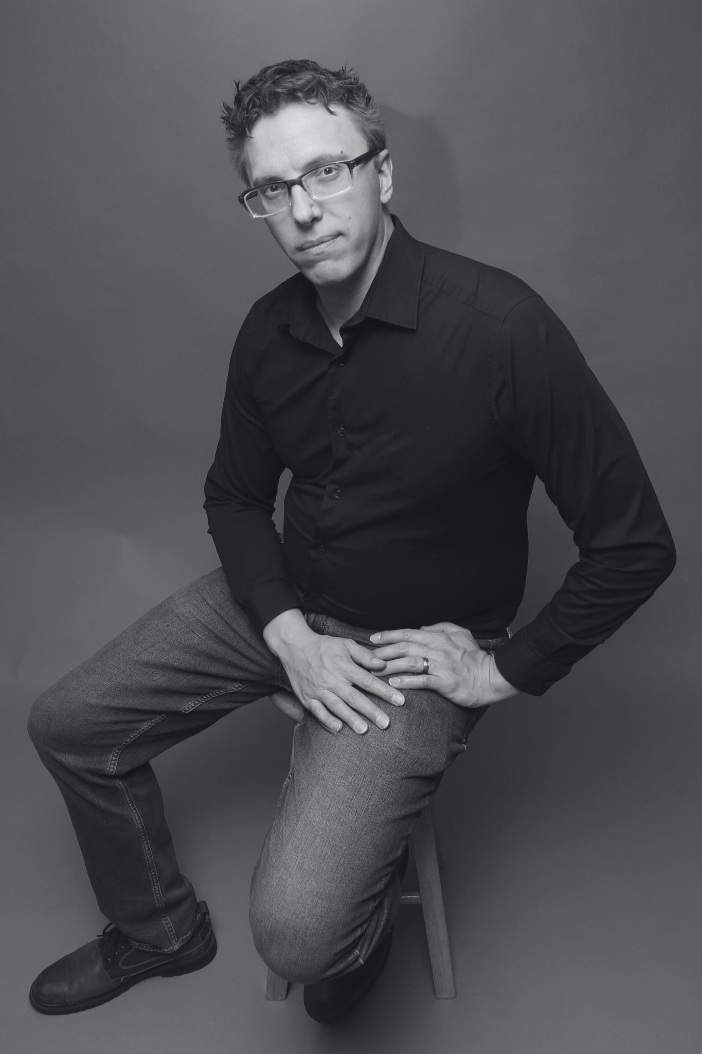 Jonathan Fritzler seated for a black-and-white portrait